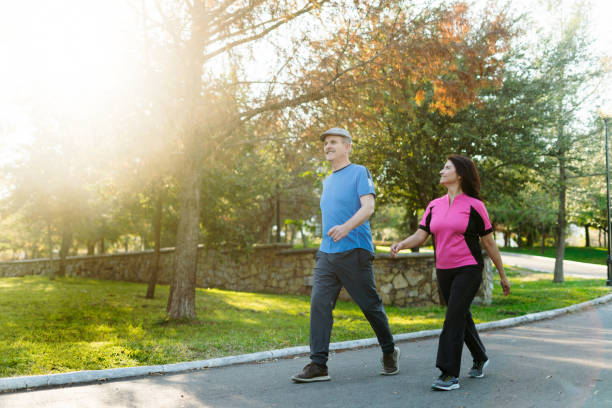 Older couple enjoying a confident, energetic walk through a park