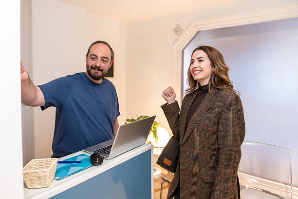 Front desk staff welcoming a patient to the clinic