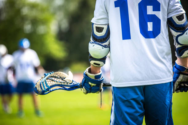 Lacrosse player holding his stick on the field during a game