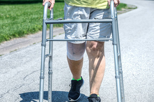 Knee replacement patient walking during physical therapy