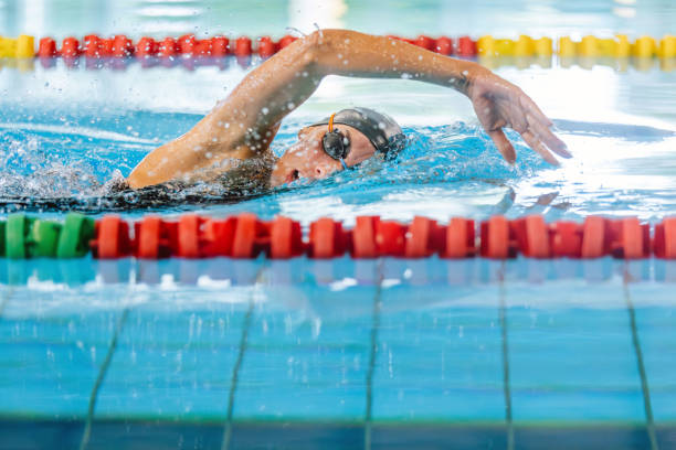 Competitive swimmer mid-stroke swimming freestyle in a pool