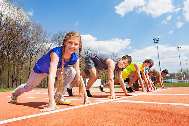 Group of teenage runners lined up and ready to race