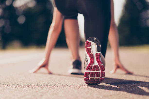 Close-up of an athlete's shoe on the starting line of a track