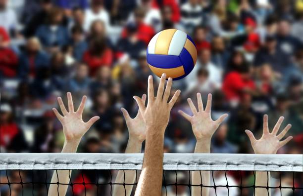 Volleyball spike being blocked at the net during a match